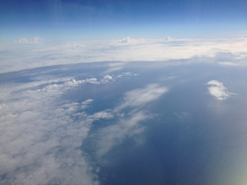 Cloud islands over the ocean on Linda’s flight home.